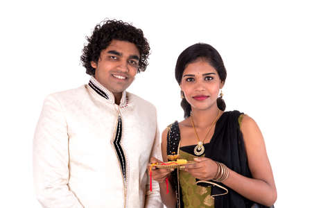 Indian brother and sister enjoying and celebrating Raksha Bandhan festivalの写真素材