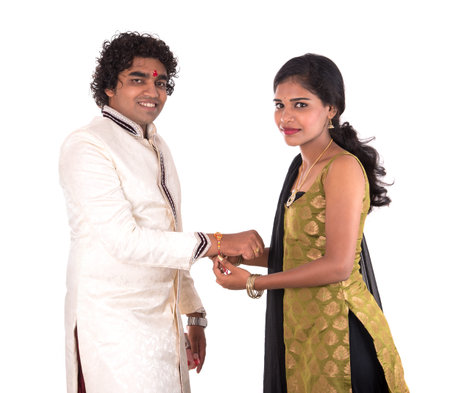 Indian young sister tying rakhi on brother's wrist, a tradition on Raksha Bandhan festivalの写真素材