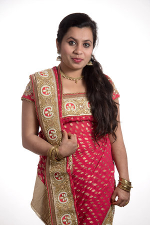 Beautiful young girl posing in Indian traditional saree on white background.