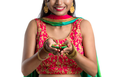 Portrait of a Indian Traditional Girl holding Diya, Girl Celebrating Diwali or Deepavali with...