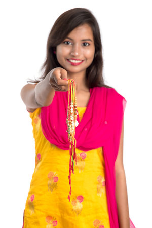 Beautiful Indian girl showing Rakhis on occasion of Raksha bandhan. Sister tie Rakhi as symbol of intense love for her brother.の写真素材