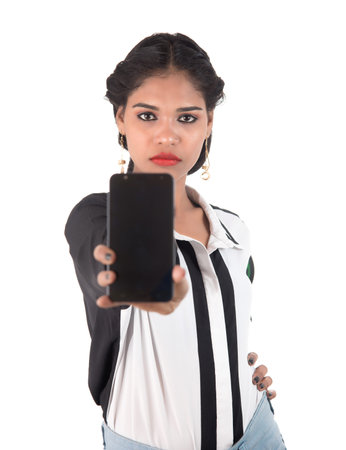 Young beautiful woman holding blank screen smart phone on white background