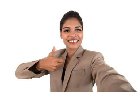 Beautiful young businesswoman using smartphone to take selfie photo isolated on white background