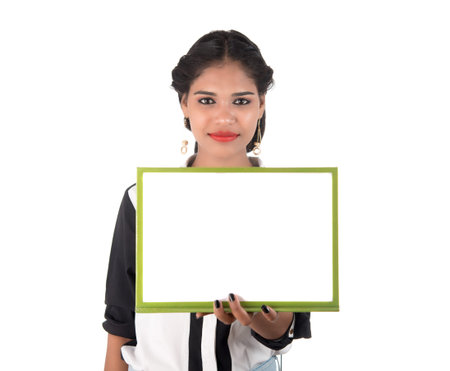 Girl holding blank white sign board on white background. Isolated portraitの写真素材
