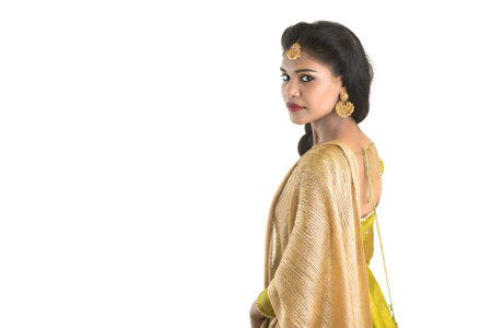 Portrait of beautiful traditional Indian girl posing on white background.
