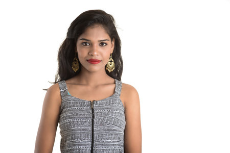 Portrait of beautiful young smiling girl posing on white background