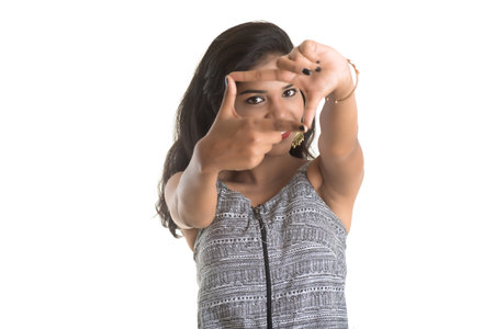 Smiling cheerful girl showing sign isolated on white backgroundの写真素材