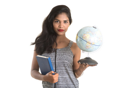 Young girl student holding book with globe on white background. Education in high school university college conceptの写真素材