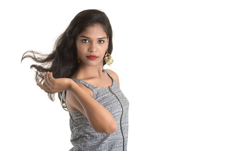 Portrait of beautiful young smiling girl posing on white backgroundの写真素材