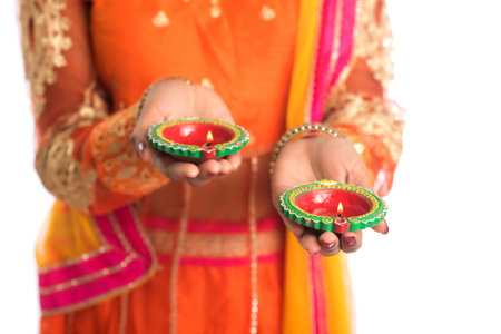 Portrait of a Indian Traditional Girl holding Diya, Girl Celebrating Diwali or Deepavali with...