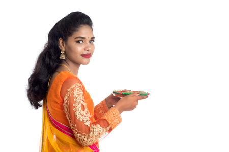 Portrait of a Indian Traditional Girl holding Diya, Girl Celebrating Diwali or Deepavali with...