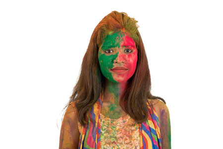 Portrait of a happy young girl with a colorful face on Holi color festival on white backgroundの写真素材