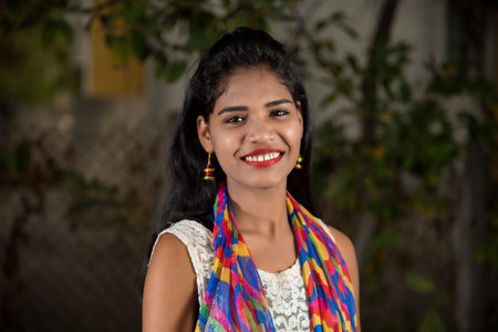 Portrait of beautiful Young girl outdoors in park.の写真素材