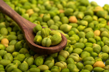 Fresh green Chickpea (Cicer arietinum) in wooden spoon with scattered chickpeas on a white background. Desi variety.の写真素材