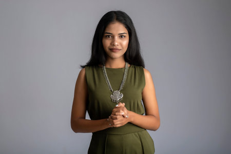 Portrait of a young girl posing on gray backgroundの写真素材