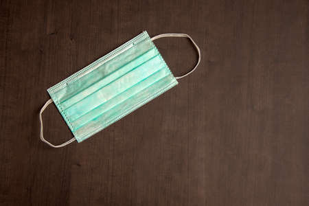 Surgical mask with rubber ear straps. Typical surgical mask to cover the mouth and nose. Procedure mask from bacteria. Protection concept.の写真素材