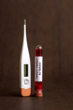 Medicine tablet and Thermometer with Test tube containing a blood sample for testing to the presence...