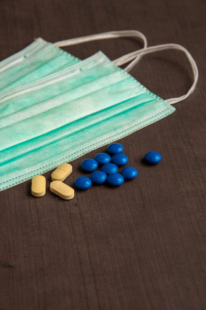 Pharmaceutical medicine tablets and medical mask. Medicine, Hygiene and Healthcare concept.