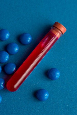 A test tube filled with a blood sample for testing and pills tablets. virus pandemic epidemic concept.の写真素材