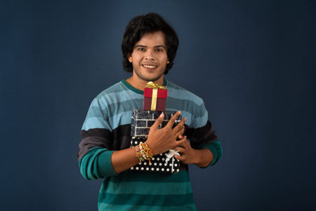 Young men showing Rakhi on his hand with gift box on the occasion of Raksha Bandhan festivalの写真素材