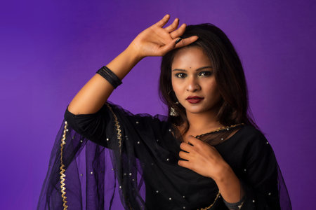 Portrait of a young girl or woman posing on purple background