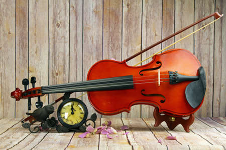A violin and a watch still life, selective focus.の写真素材
