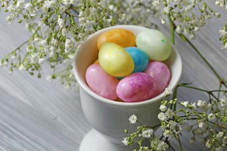 Easter Candy with spring flowers close up with copy space, selective focusの写真素材