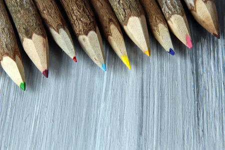 Wooden pencils in a pencil stand on a wooden background with copy space.の写真素材
