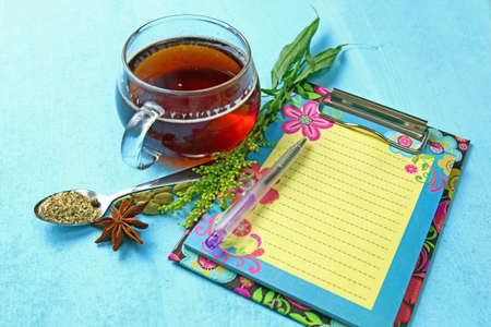A cup of black tea and spices with copy space on blue background, selective focus.の写真素材
