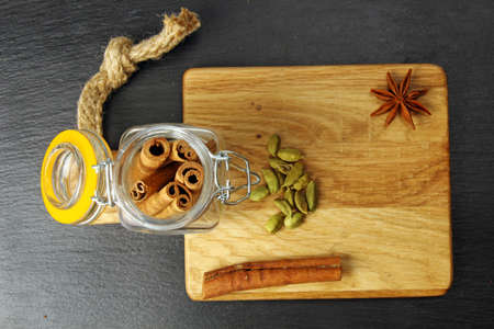 A wooden board with cinnamon sticks in a jar, selective focus.の写真素材
