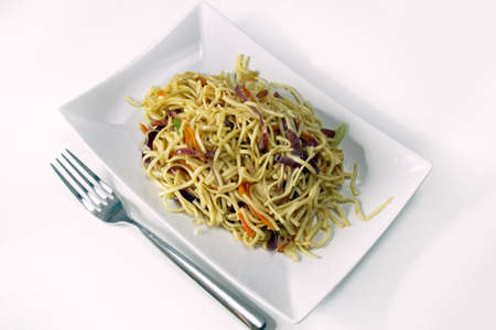 Overhead view of Chinese vegetarian noodles on white background with copy space.の写真素材