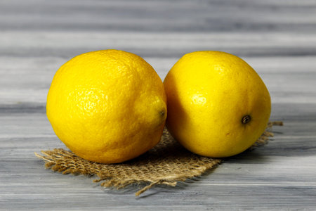 Close up of two largeyellow  lemons on a wooden background