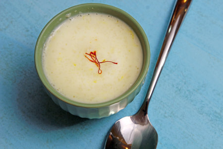 A bowl of Phirini, an Indian dessert made of coarsely ground rice cooked in milk