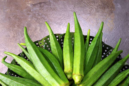 Okra of Lady's finger in a colander with copy spaceの写真素材