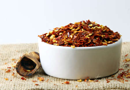 Crushed red pepper in a bowl with shallow depth of fieldの写真素材