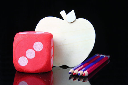 Blue and red pencils with an apple cutout on a black background for the back to school theme with copy space.の写真素材