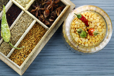 Overhead view of a glass jar of yellow split lentils or arhar daal, selective focus and copy space