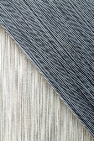Textured grey and black striped background filling the frame, vertical version