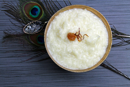 Overhead view of rice kheer or rice pudding in a bowl on grey background with copy space.の写真素材