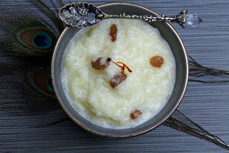 Overhead view of rice kheer or rice pudding in a bowl on grey background with copy space.の写真素材