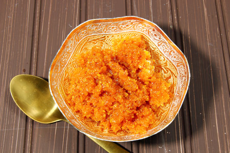 Gajar halwa or carrot dessert in a bowl on a moody dark background, copy spaceの写真素材