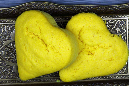 Top view of Brazilian corn bread in the shape of a heart on a trayの写真素材