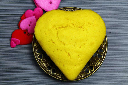 Top view of Brazilian corn bread in the shape of a heart on a plateの写真素材