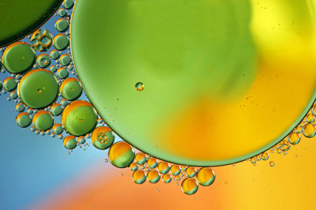 Oil in water forming blue and green circles abstract background