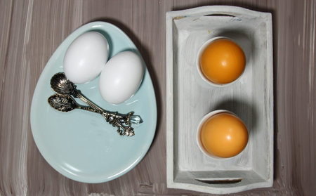 Top view of a  table setting of plates and eggs for breakfastの写真素材