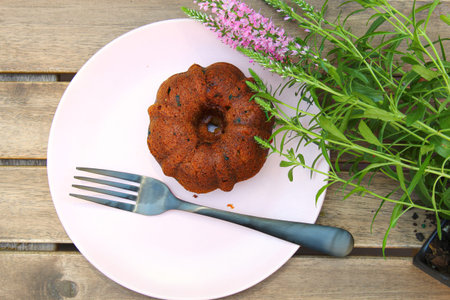 Small banana bread Bundt cakes on a wooden background with copy spaceの写真素材