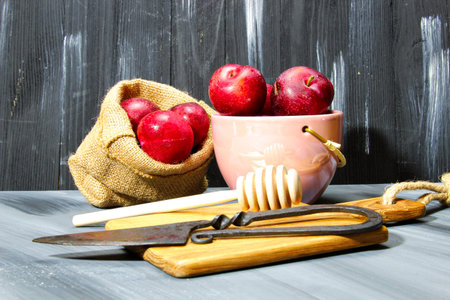 Overhead shot of Red Cherry plums on grey backgroundの写真素材