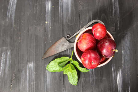 Overhead shot of Red Cherry plums on grey backgroundの写真素材