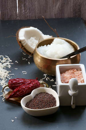 Mustard seeds and Himalayan salt with other spices and Coconut oil, ingredients for cooking. Selective focus.の写真素材