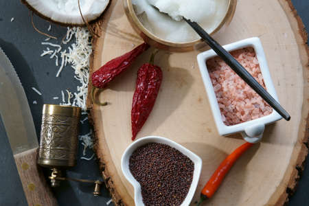 Mustard seeds and Himalayan salt with other spices and Coconut oil, ingredients for cooking. Selective focus.の写真素材